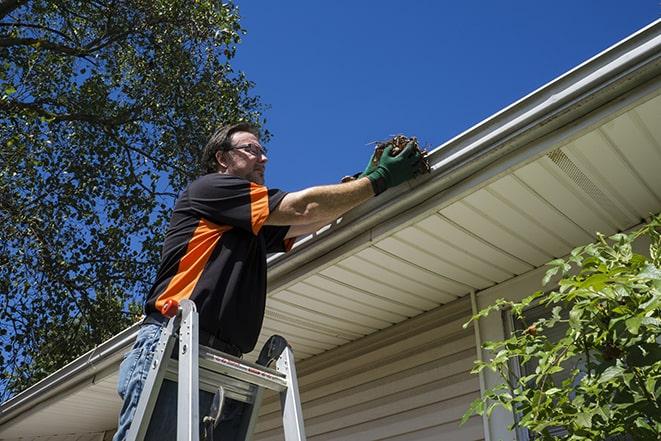 home maintenance worker repairing a leaky gutter in East Palatka